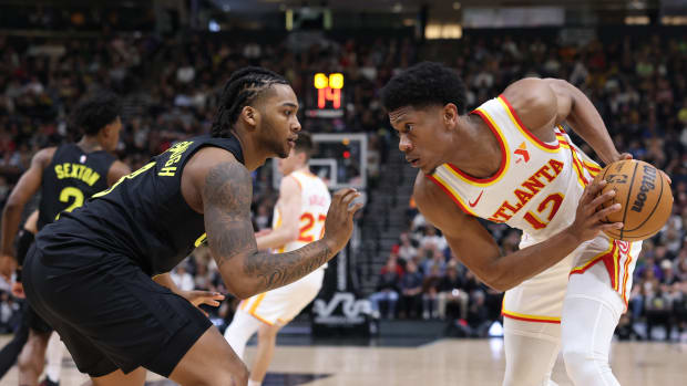 Mar 15, 2024; Salt Lake City, Utah, USA; Atlanta Hawks forward De'Andre Hunter (12) looks to move the ball against Utah Jazz forward Brice Sensabaugh (8) during the second quarter at Delta Center. Mandatory Credit: Rob Gray-USA TODAY Sports